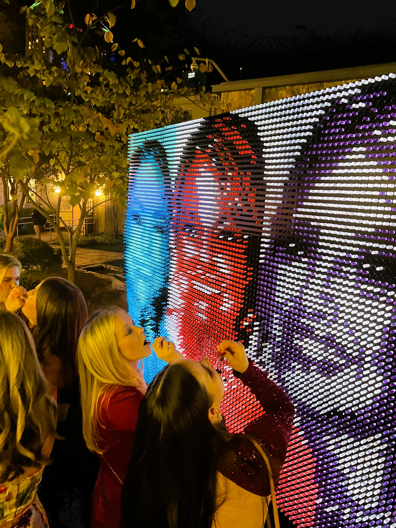 Guests interacting with an illuminated art installation